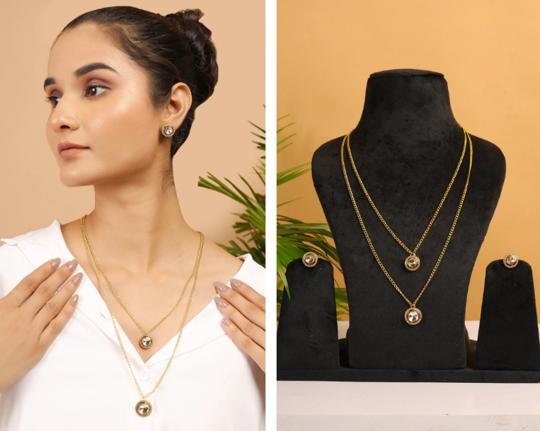 Woman wearing a gold necklace with a matching earring, displayed on a mannequin.