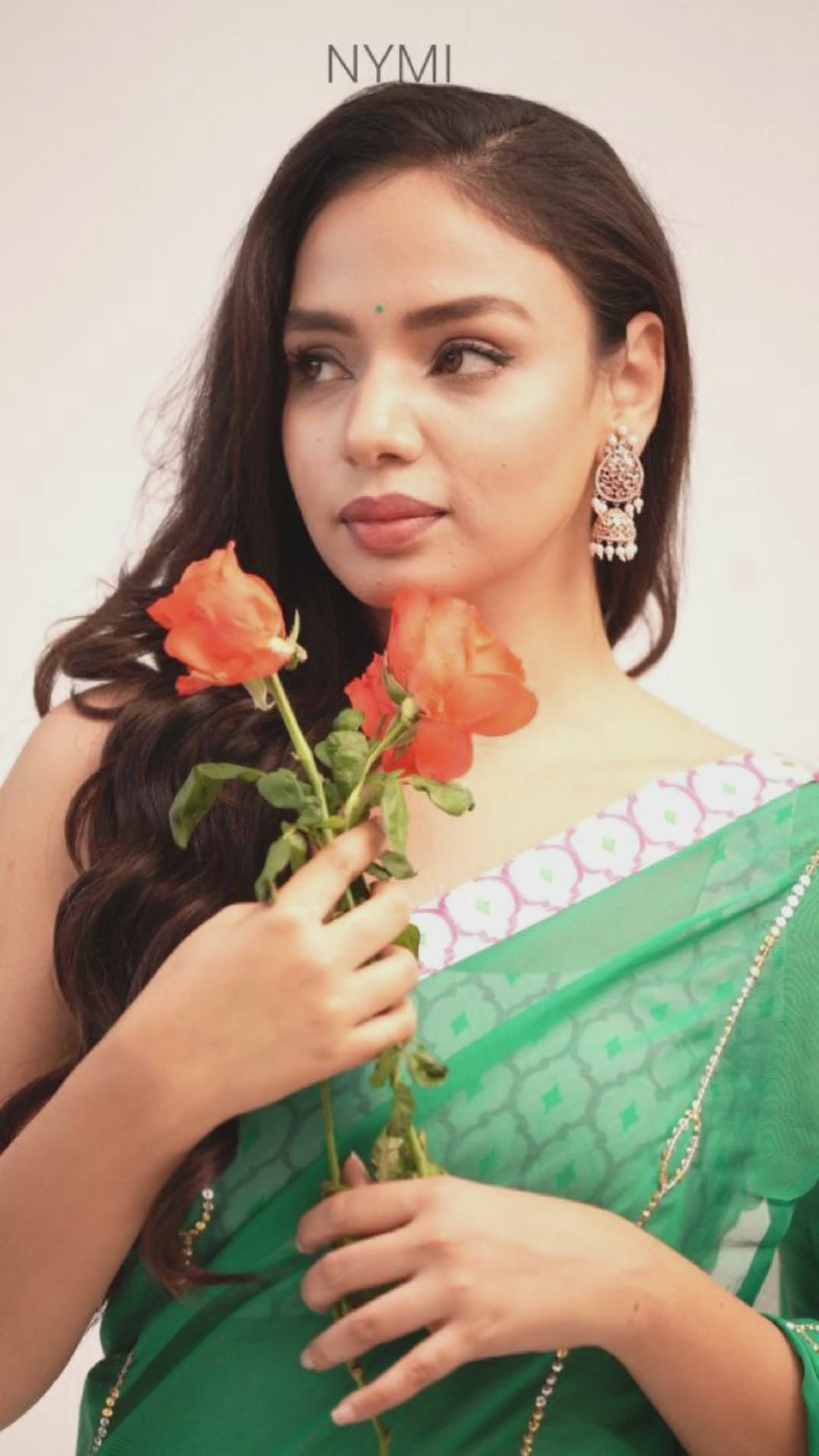Load video: Mandhaara Aranya Emerald Green Floral Organza Saree with Pink Border - Festive Occasions